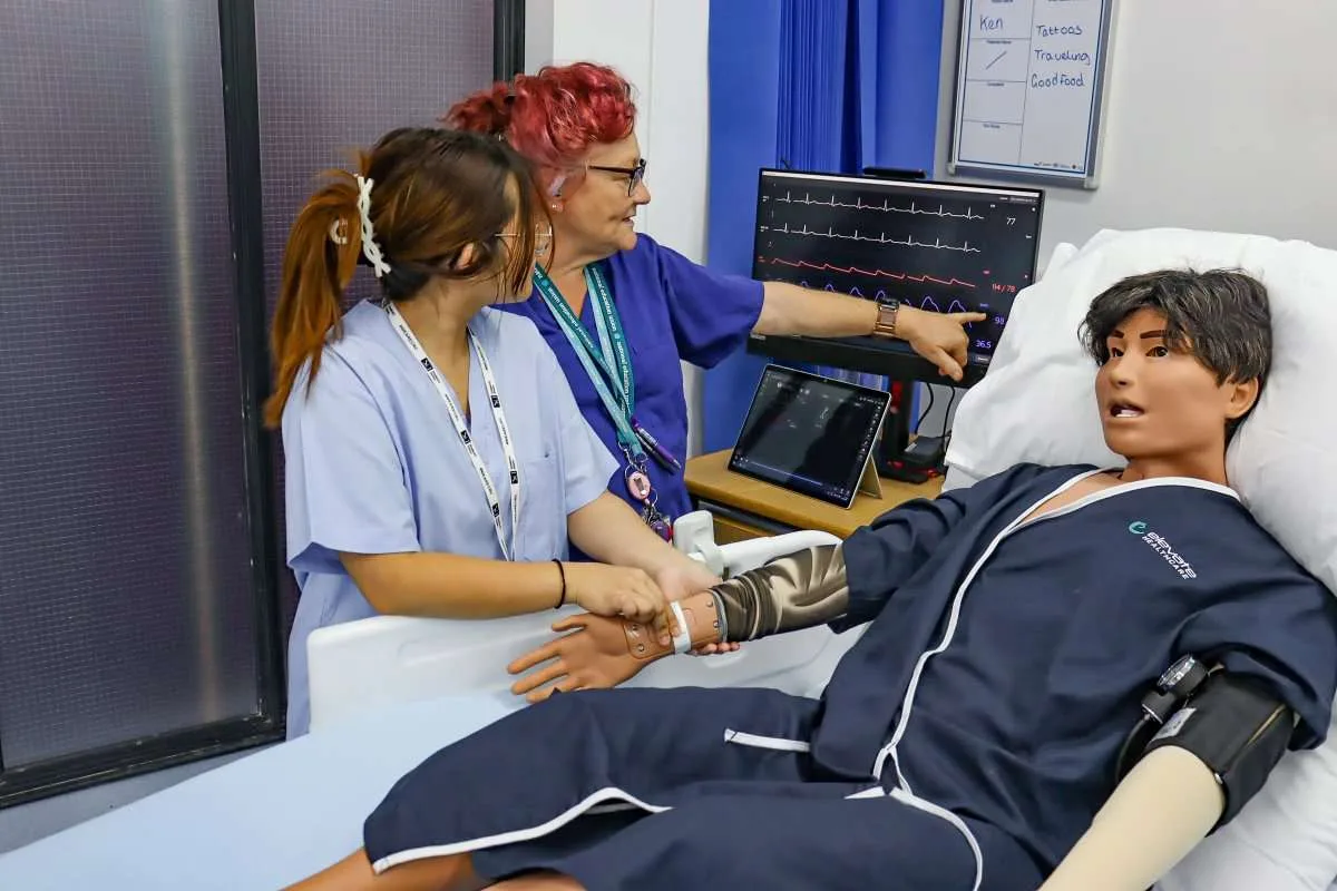 T Level Health students check a simulation mannequin's heart trace and blood pressure in The Ward on its opening day, 25 September