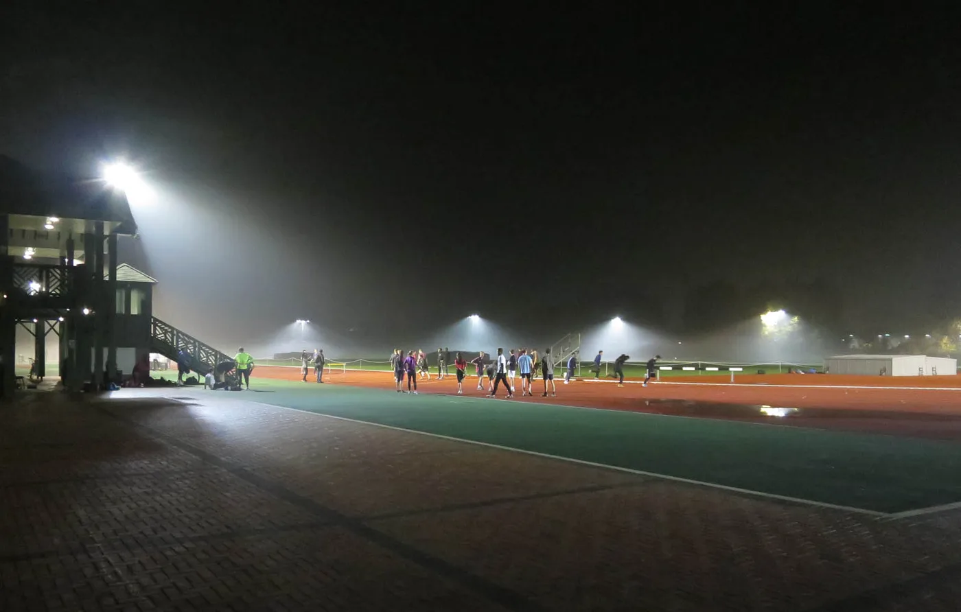 The existing floodlights at the Wilberforce Road athletics track on a misty evening in November 2015. These are the lights being replaced; the photograph does not show the new columns